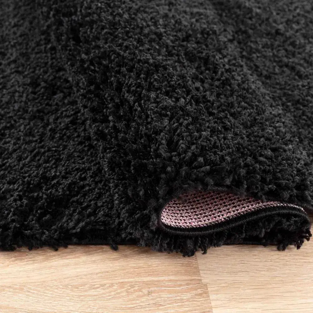 closeup of soft black shaggy rug in a modern living room
