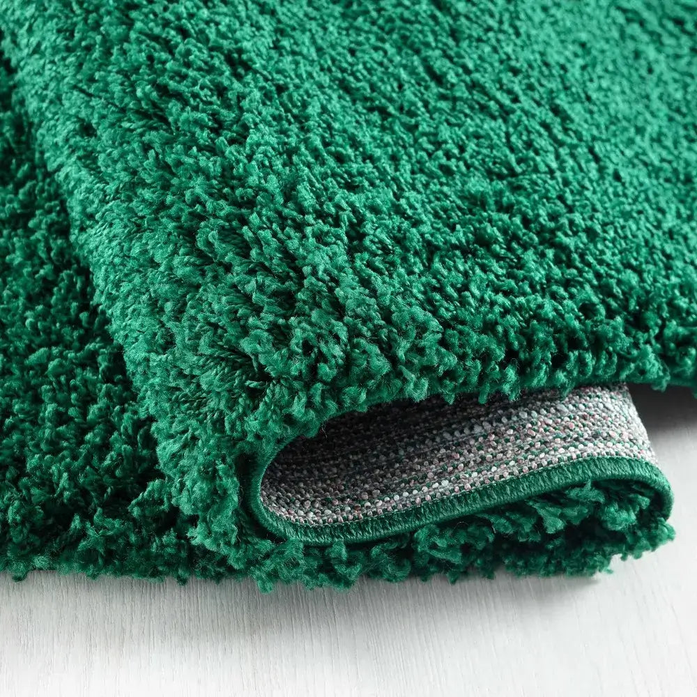 closeup of soft emerald shaggy rug in a modern living room